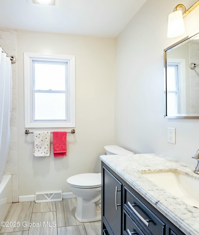 full bathroom with a wealth of natural light, visible vents, toilet, and vanity