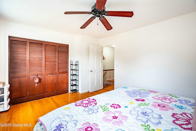 bedroom featuring a closet, ceiling fan, and wood finished floors