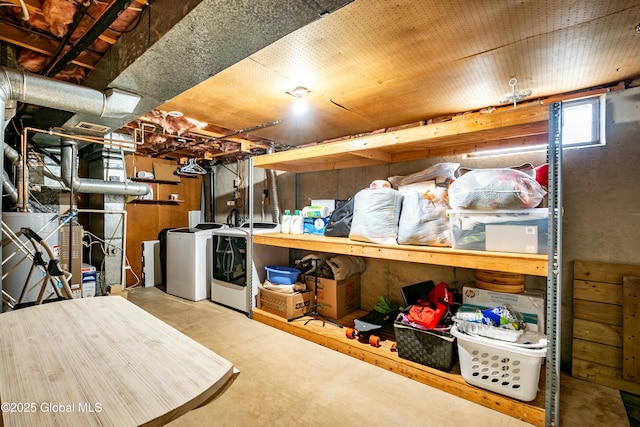 basement with gas water heater and washing machine and clothes dryer