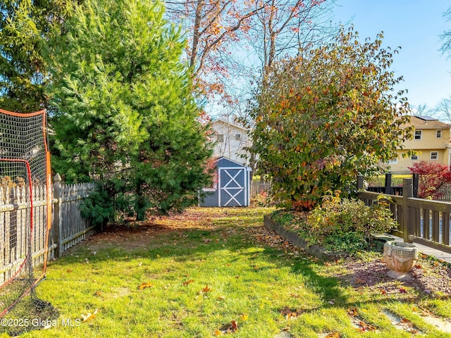 view of yard featuring a storage shed, an outbuilding, and a fenced backyard