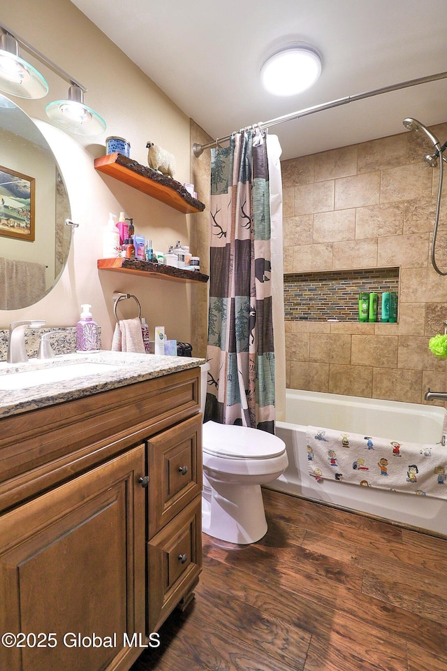 full bathroom featuring vanity, toilet, wood finished floors, and shower / bath combination with curtain