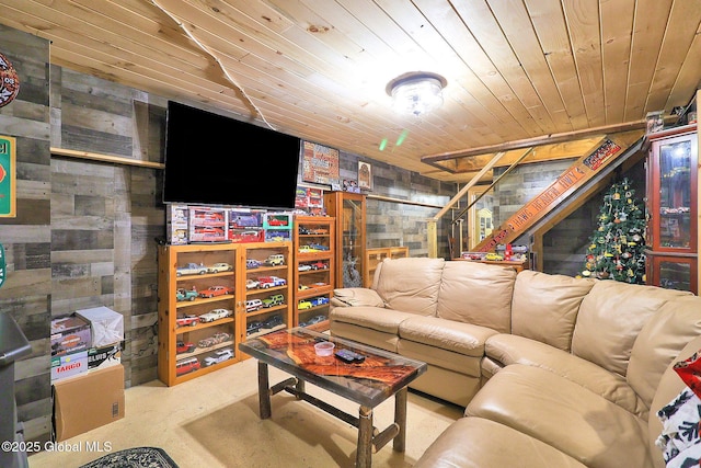 living room featuring wooden walls, concrete flooring, and wood ceiling
