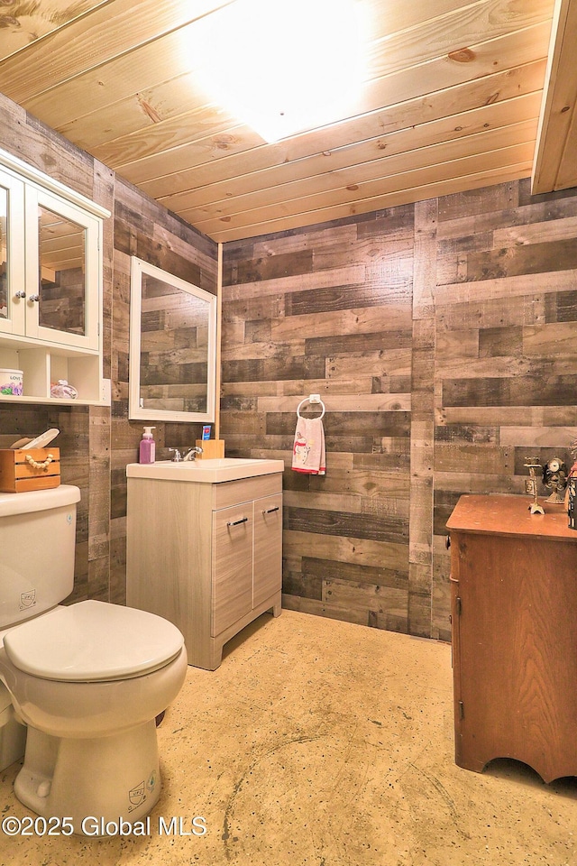 bathroom with vanity, wooden ceiling, toilet, and wood walls