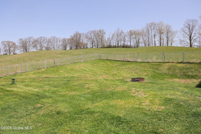 view of yard featuring fence and a rural view
