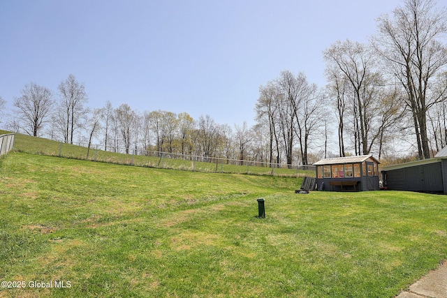 view of yard with an outdoor structure, exterior structure, and fence