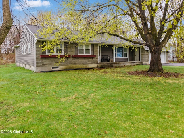 ranch-style home featuring covered porch, an attached garage, driveway, and a front lawn