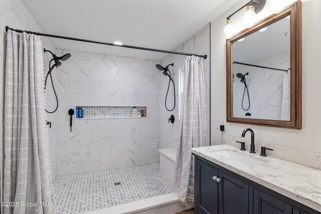 bathroom featuring recessed lighting, a tile shower, and vanity