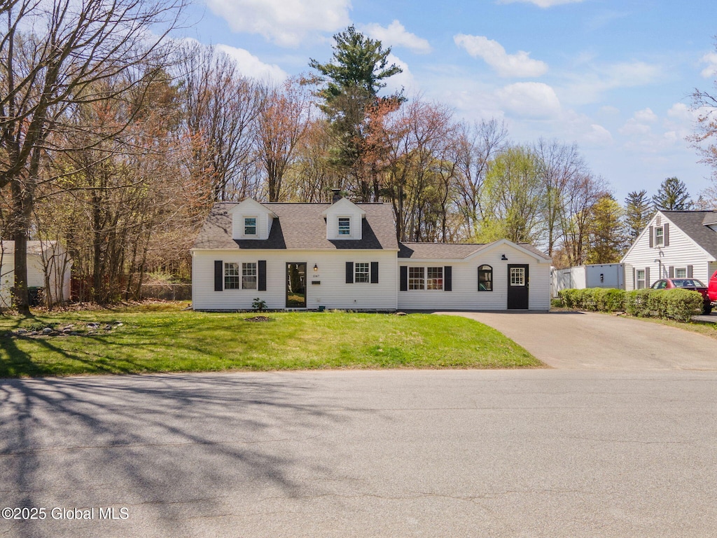 cape cod house featuring a front yard and aphalt driveway