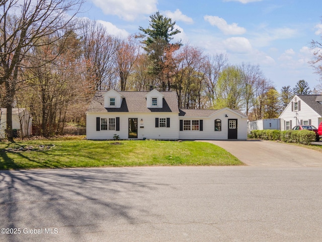 cape cod house featuring a front yard and aphalt driveway