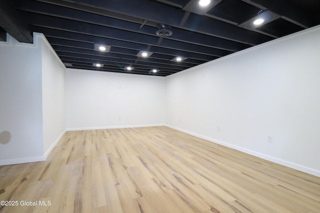 finished below grade area featuring light wood-style floors and baseboards