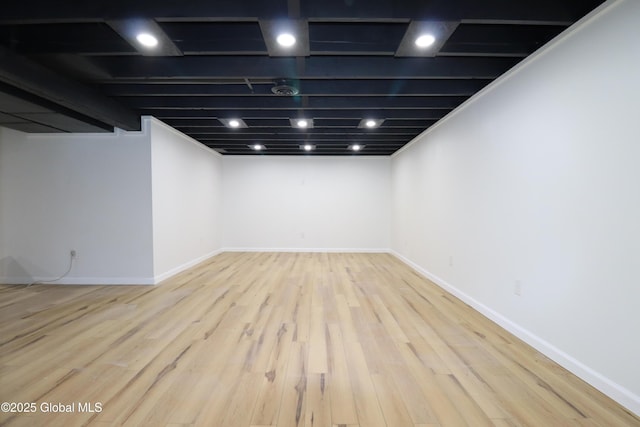 finished basement with baseboards and wood finished floors