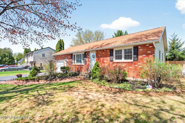 single story home featuring a front lawn and brick siding