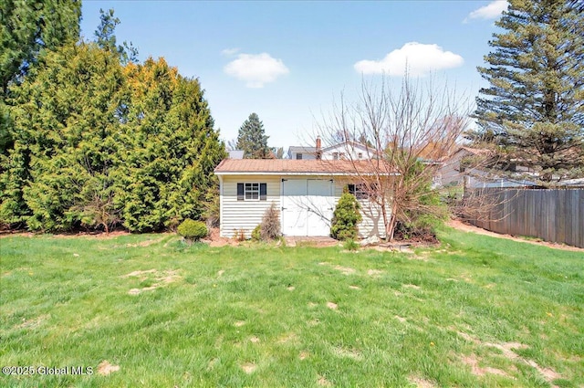 exterior space featuring fence and a lawn