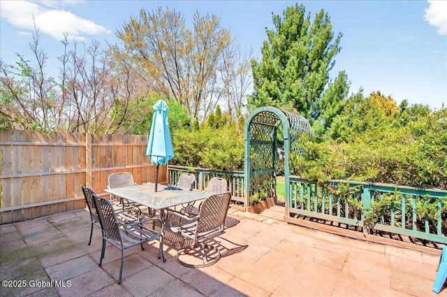 view of patio featuring fence and outdoor dining space