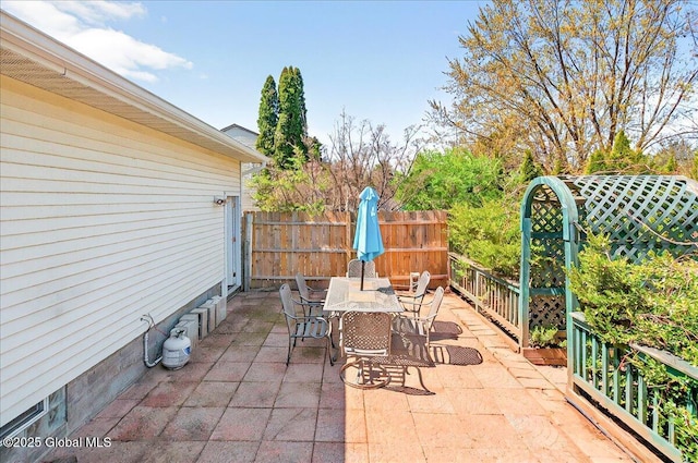 view of patio / terrace featuring fence and outdoor dining area
