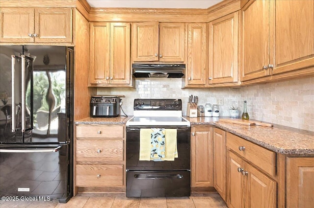 kitchen featuring ventilation hood, light stone countertops, black appliances, and tasteful backsplash
