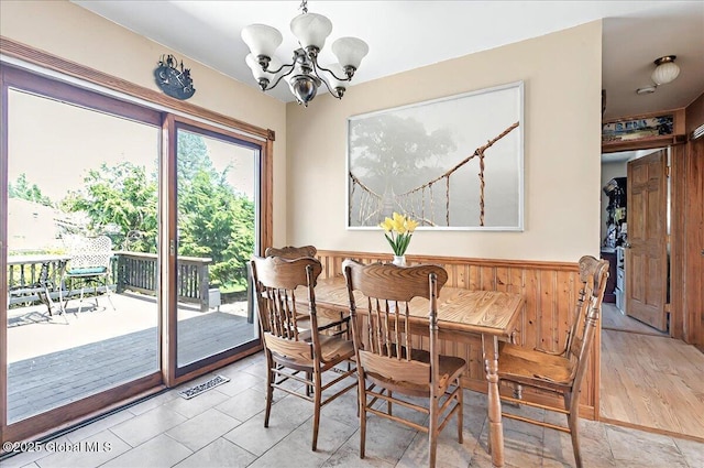 dining area featuring an inviting chandelier, wainscoting, and visible vents