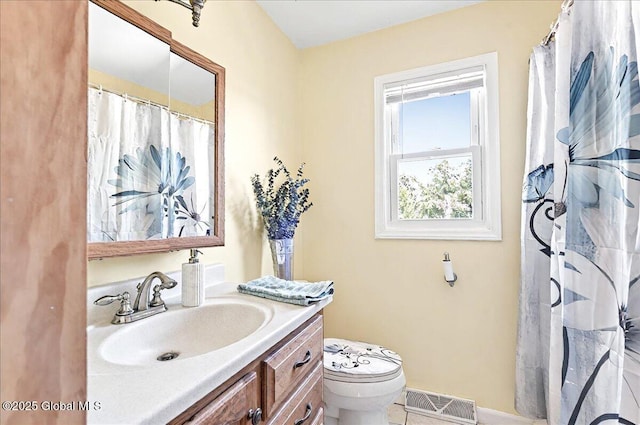 bathroom with visible vents, tile patterned flooring, vanity, toilet, and baseboards