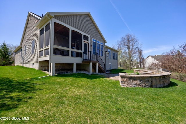 back of house with a yard, stairs, and a sunroom