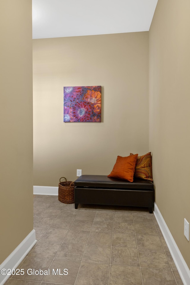 sitting room with baseboards and light tile patterned floors