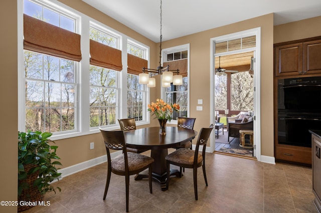 dining space with baseboards, plenty of natural light, and tile patterned flooring