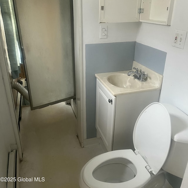 21 Depot St, Greenwich, NY 12834 - bathroom with toilet, vanity, a baseboard heating unit, and concrete floors