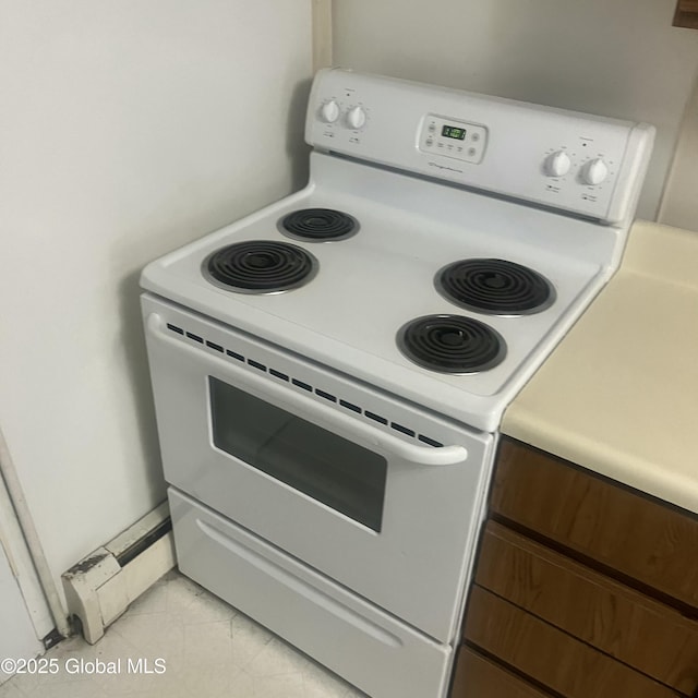 21 Depot St, Greenwich, NY 12834 - kitchen with white range with electric stovetop, light countertops, and light tile patterned floors