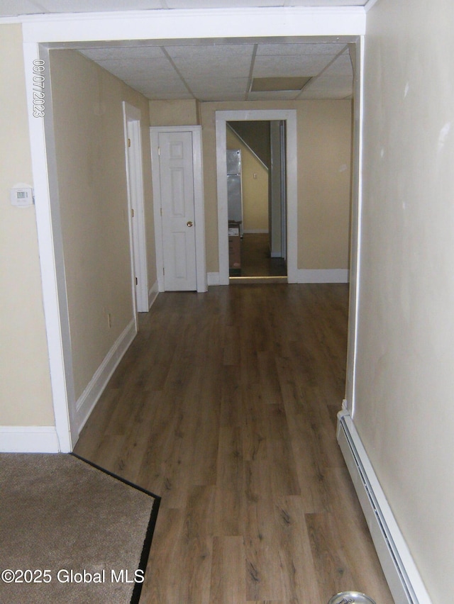 21 Depot St, Greenwich, NY 12834 - hallway with a baseboard heating unit, a drop ceiling, wood finished floors, and baseboards