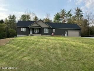 view of front of home with an attached garage and a front yard