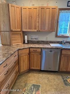 kitchen featuring stainless steel dishwasher and light stone countertops