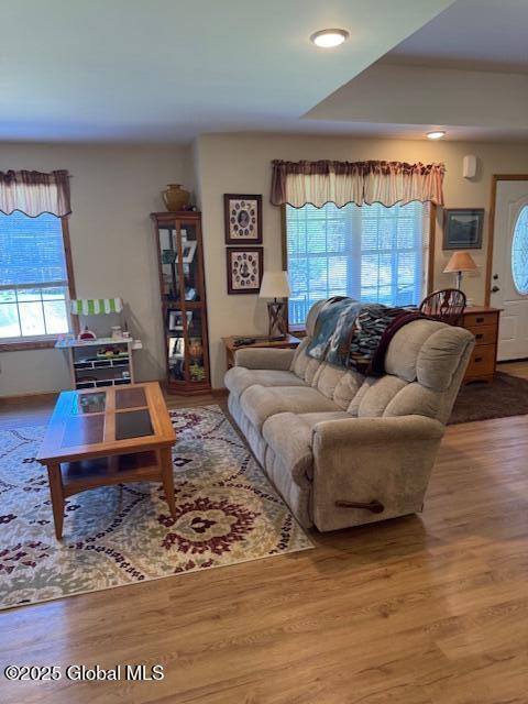 living room with recessed lighting, plenty of natural light, and wood finished floors