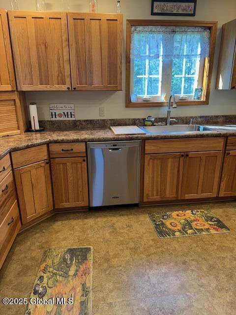 kitchen featuring a sink, dark countertops, brown cabinetry, and dishwasher