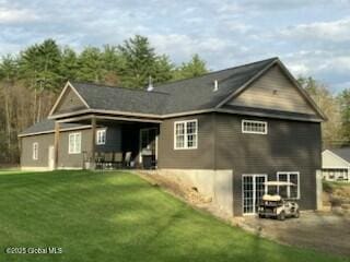 rear view of house with a lawn and a patio area
