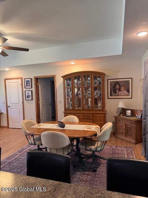 dining room featuring light wood-type flooring, a ceiling fan, and recessed lighting