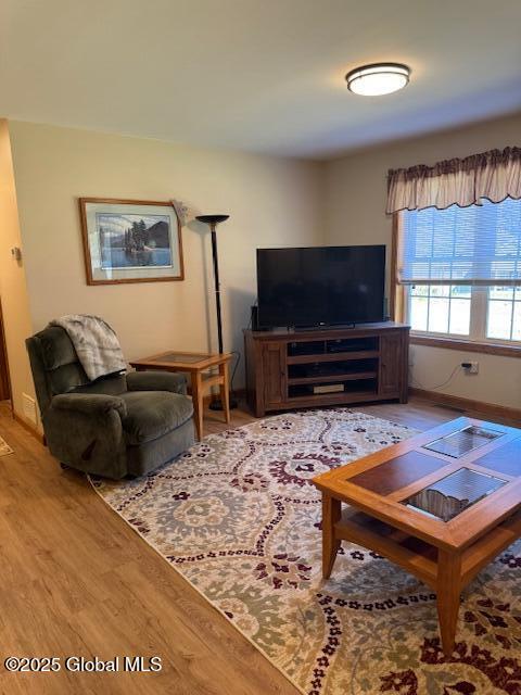 living room featuring baseboards and wood finished floors