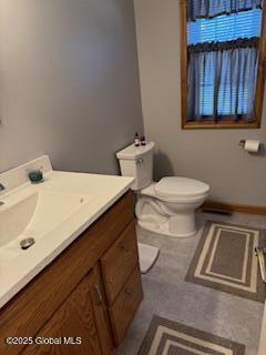 bathroom featuring vanity, baseboards, and toilet