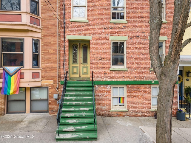 doorway to property with brick siding