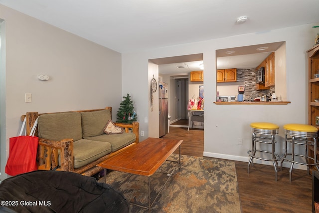 living room with baseboards and wood finished floors