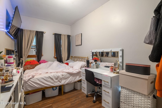 bedroom with cooling unit and wood finished floors