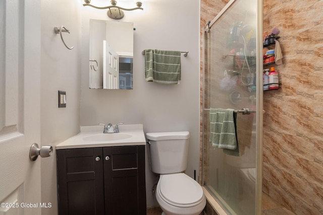 bathroom featuring vanity, a stall shower, and toilet