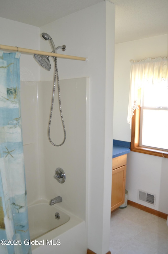 full bathroom featuring baseboards, visible vents, and shower / bath combo with shower curtain