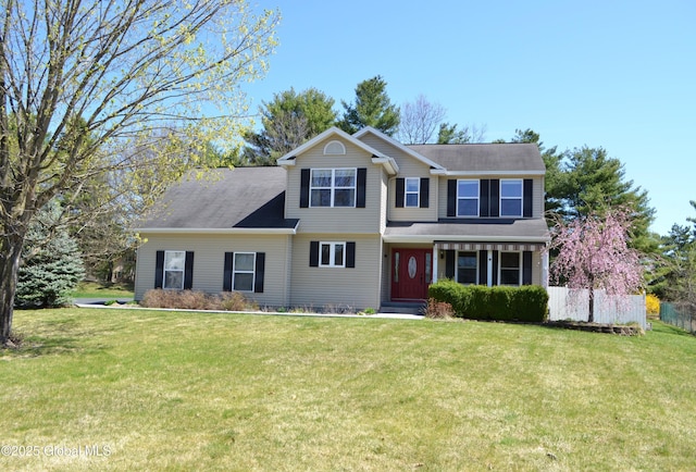 traditional home with fence and a front yard