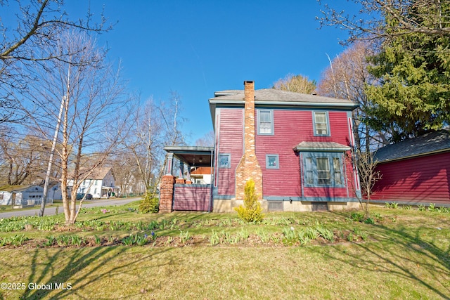 18 1st Ave, Mayfield, NY 12117 - rear view of house with a yard and a chimney