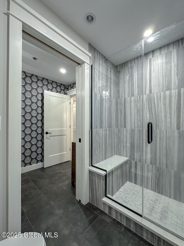 bathroom featuring baseboards, a shower stall, and tile patterned floors