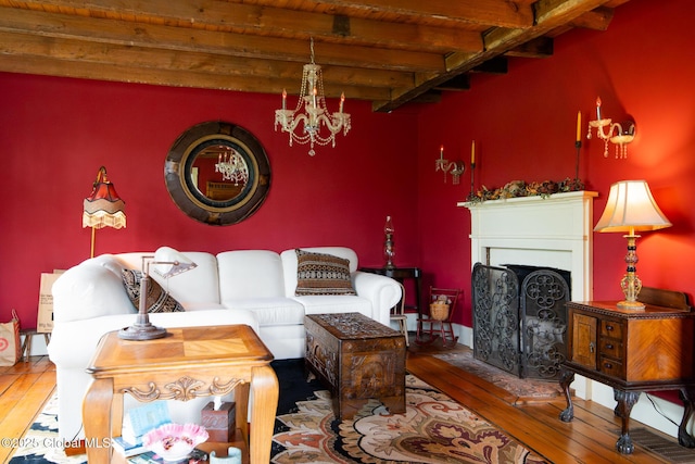 71 S Rd, Hampton, NY 12887 - living room featuring hardwood / wood-style floors, beamed ceiling, a chandelier, a fireplace, and wooden ceiling