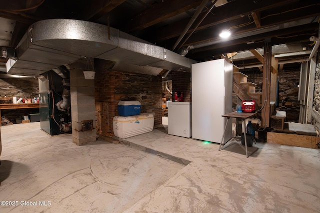 71 S Rd, Hampton, NY 12887 - unfinished basement with independent washer and dryer, heating unit, and fridge