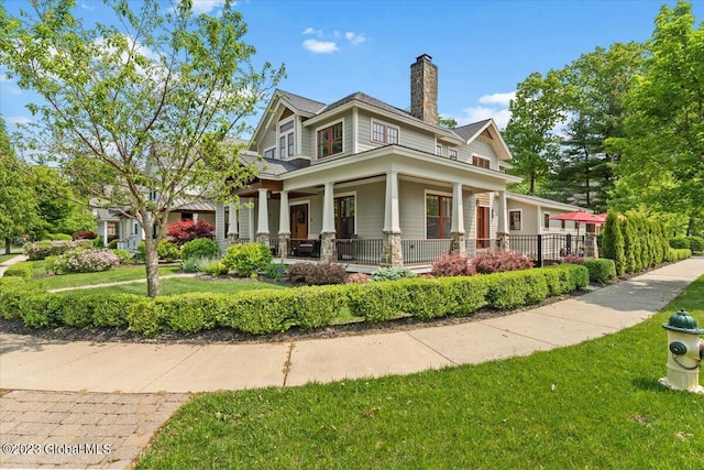 20 Oak Ridge Blvd, Saratoga Springs, NY 12866 - view of front of house featuring a porch, a front yard, and a chimney