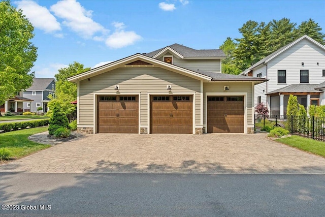 20 Oak Ridge Blvd, Saratoga Springs, NY 12866 - view of front facade featuring fence, an attached garage, decorative driveway, and stone siding