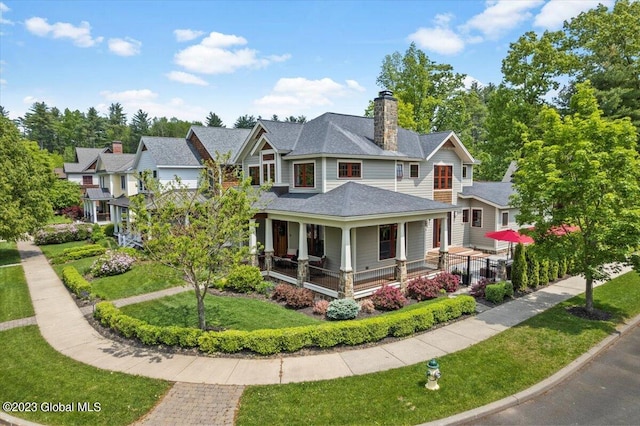 20 Oak Ridge Blvd, Saratoga Springs, NY 12866 - victorian house featuring covered porch, a chimney, and a front yard