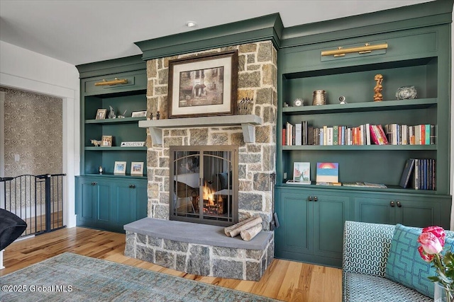 20 Oak Ridge Blvd, Saratoga Springs, NY 12866 - living area with a stone fireplace, built in features, and light wood finished floors
